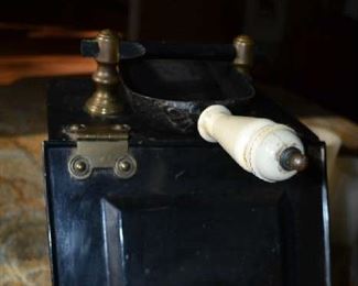 1800's antique coal scuttle with heavy brass accents.  All metal with handle and porcelain shovel, sleeve in back to hold it.  Solid, heavy piece. Great antique condition.  Ready for use again.