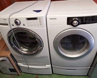 6951: LG Tromm Front Load Steam Washer and Samsung Sensor Dry Front Load Dryer
Featured here is an LG Tromm Steam 24” front loading washer with 4.0 ultra-capacity washing machine. Features 6 motion technology, tub clean cycle, smart diagnosis, direct drive motor. 3 soil levels, 10 wash programs, with load sense water level features as well. This washer is paired here with a Samsung 7.3 cu.ft 7 cycle gas dryer, white with gray accents. Features 7 preset dry cycles, 4 temp control settings, sensor dry technology, 3-way venting, reversible see-thru door and LED display.