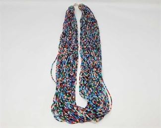 140: One of a Kind Large American Indian Beaded Necklace w/Turquoise/Oyster ends set in Heavy Sterling
Featured here is a Approx 70 Strand STUNNING multi-colored Native American hand beaded necklace with sterling silver binding and lobster claw closed-hook clasp. Beautifully hand beaded strands casually twist around one another to create a beautiful cascade of color sweeping around the neck. Lovely! Weighs approx 256.3g Measures approx 36.5
Low Estimate: 650.00
High Estimate: 850.00