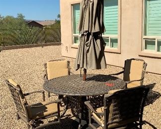 Patio Table with umbrella and four chairs 	 	
