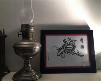 Antique oil lamp and Asian print.