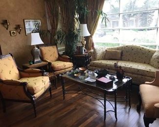 Sweet suite featuring Bergere style chairs with a damask upholstery of dragonflies, floral love seat, fruitwood nesting tables, Asian decor, potted tree, silk damask creamy yellow striped curtains....