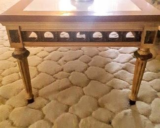 Side view of 1960's Coffee Table with brass encircling  open holes.