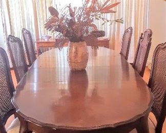 Large French Provincial.Dining Room Table with 2 over-sized leaves, 6 matching chairs, and 1 chair that is similar to the other 6.