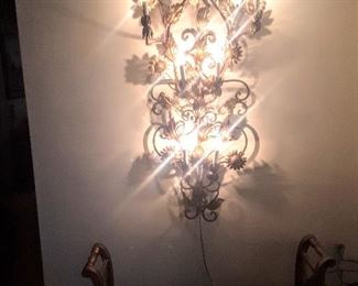 Beautiful Guilded Gold-Leaf wall hanging lamp lighted up.