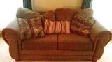 Really Nice Upholstered Love Seat with lots off soft cushions and pillows