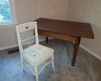 Primitive table and wicker chair