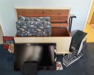 Lane Beige Chest with large lower blanket shelf and upper small shelf for collectibles. Blanket. Bike Wire Basket. RCA TV with TIVO and Manual. Canes. Comforter. Small Books.