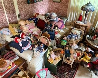 Dolls and a sofa under all those dolls