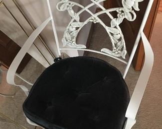 There is a white wrought iron patio set in the garage.