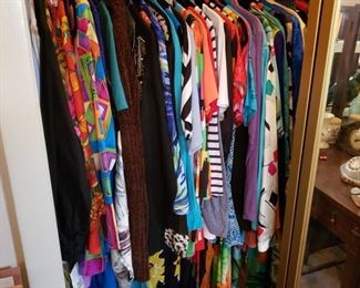 bedroom 2 has a full closet and a large rack of vintage clothing