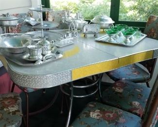 Retro kitchen table. Set of four chairs do not match table. Lots of aluminum serving pieces.