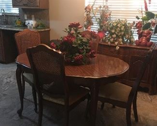 Nice dining table with one leaf and six cain back chairs.