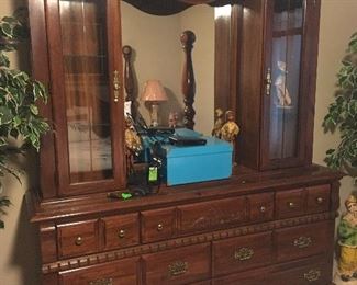 Interesting dresser with curio displays on either side.