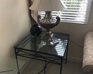 Many wrought iron and glass side tables and coffee tables