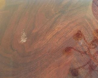 Small scratch on table surface. 1-1/2” long. Less noticeable in person.