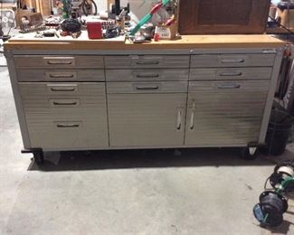Super nice work bench has chrome face and solid wood top, on wheels and easy to move, lots of storage space