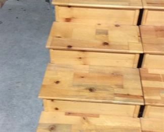 Two sets of wooden steps, each step lips off with a hidden compartment for lots of storage
