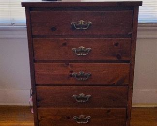Dark pine chest of drawers with brass bale handles