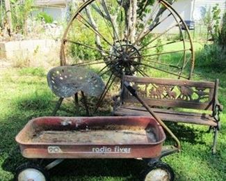 Vintage Radio Flyer 90 wagon, bench, and two vintage farm implement 52" wheels.