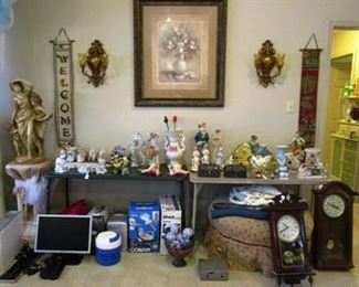 lots of figurines, wall clock, statue on pedestal, etc.