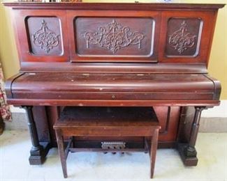 Vintage Wurlitzer piano with bench close-up view