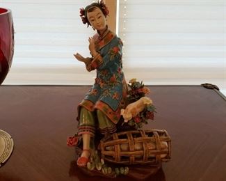 Porcelain figurine of a Chinese female with pigs