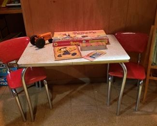 Child's formica table and two red vinyl and chrome chairs