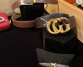 Gucci belts and a David Yurman bracelet