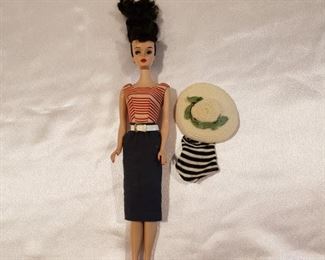 Did I mention this house has a little of everything? We just found this 1958 Barbie with original swimsuit and extra outfit with hat. She is marked MCMLVIII Japan on bottom of Left foot and #16 on bottom of Right foot