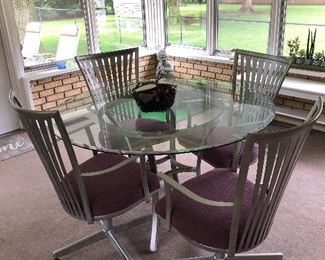 Very nice glass top table and 4 chairs.