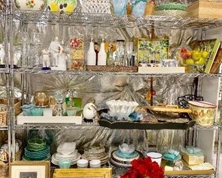 Staging supplies including framed art, artificial flowers, flower pots, glassware, accessories