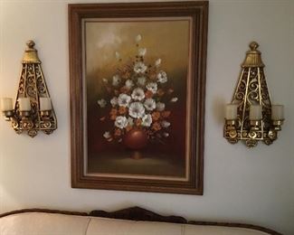 Picture over living room sofa and wall decor candle holders