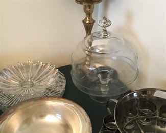 Pedestal cake plate with dome lid, metal urn, round silver serving plate with glass insert and additional pieces of glass