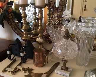 More glass ware, candlesticks, and Remington sad irons on fireplace mantle