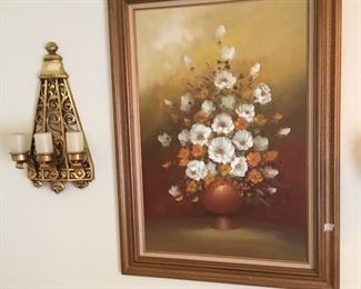 Sconce next to oil painting