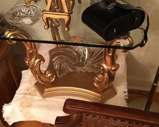 Bottom of a pair of gold swirl leg base and glass table