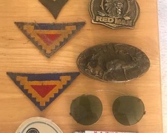 Military patches, bullet pencil, belt buckles.