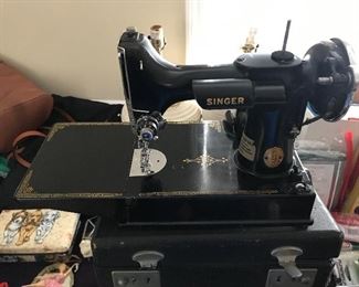 Feather weight sewing machine with folding table. 
