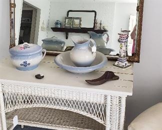 wicker table, gold beveled mirror, pottery