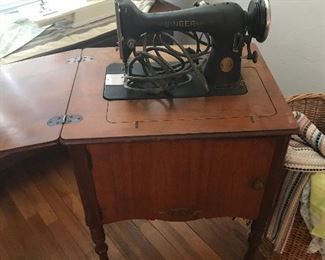 antique singer machine in cabinet