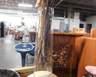 Tall transparent vase with foliage