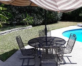Patio table and chairs. Shown with a umbrella but one spine broke in the last storm 