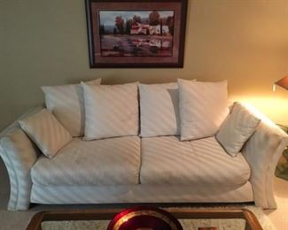  Stylish White/Cream Sofa with Pillows, some spots need cleaning but in Great condition. Approx. 7.5 feet long
