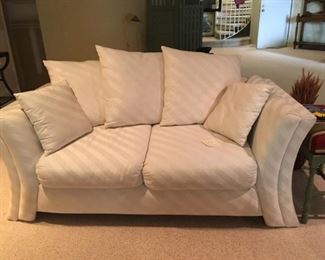 Stylish White/Cream Love Seat Sofa with Pillows, some spots need cleaning but in Great condition. Matches 19
