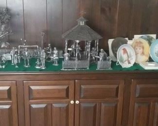 wooden cabinet filled and topped with collectibles, pewter, plates etc