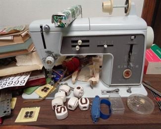 sewing machine in cabinet w/notions & some fabric