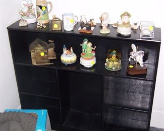 BLACK BOOKCASE AND FIGURINES