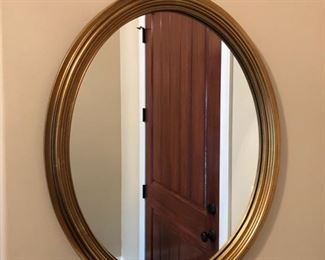 Gold framed round mirror
