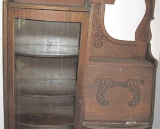 Antique oak curved glass secretary with beveled mirror.